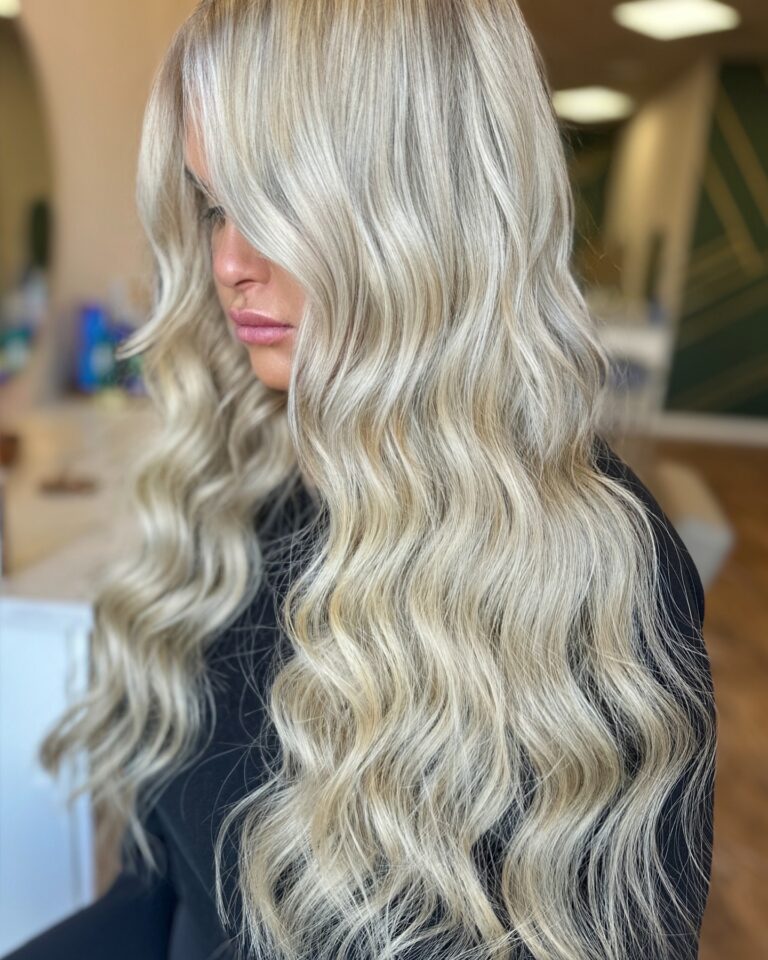 Woman with long hand-tied NBR™ hair extensions styled by Erika Creston