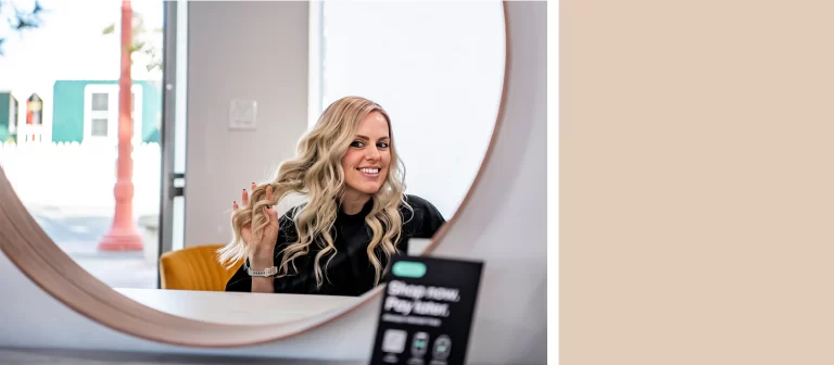 Professional hair color application showing dimensional highlights and lowlights on long hair at Vamp Salon Extension Studio
