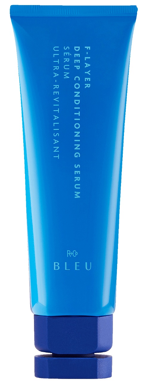 F-LAYER CONDITIONING SERUM - R+Co available at Vamp Salon Brentwood - Vamp Salon Extension Studio Blue squeeze tube of deep conditioning serum with vertical white text along the tube, branding 'BLEU' and small 'R+CO' logo near the bottom.
