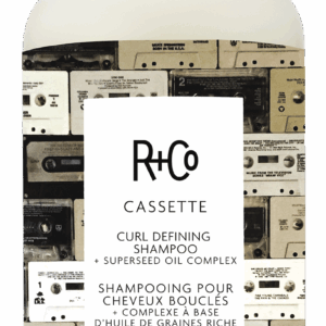 White shampoo bottle with cassette-tape collage label from R+Co Cassette Curl Defining Shampoo, 251 ml (8.5 fl oz).