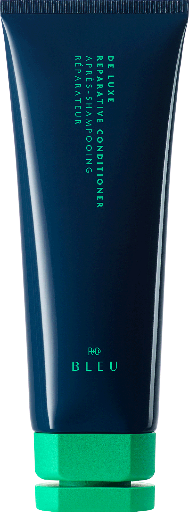 DE LUXE REPARATIVE CONDITIONER - R+Co available at Vamp Salon Brentwood - Vamp Salon Extension Studio Dark blue tube labeled 'R+Co BLUE' De Luxe Reparative Conditioner with a bright green cap at the bottom, vertical text.